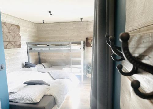 a room with two bunk beds in it at Chalet le petit Nicolas, jacuzzi, vue Mont Blanc in Chamonix-Mont-Blanc