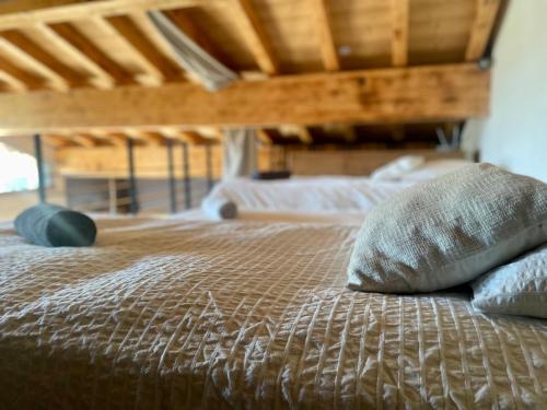 a bed with two pillows on top of it at Chalet le petit Nicolas, jacuzzi, vue Mont Blanc in Chamonix-Mont-Blanc
