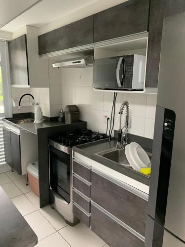 a kitchen with a sink and a microwave at Rio Stay Suite B in Rio de Janeiro