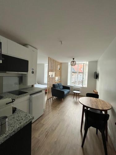 une cuisine et un salon avec une table et un canapé dans l'établissement Au coeur de la Vieille Ville - Vue Cathédrale, à Boulogne-sur-Mer