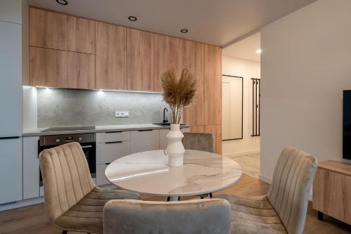 a kitchen with a table and chairs in a room at Modern 2 bedroom Vytenio apartment in city centre I Self check-in in Vilnius