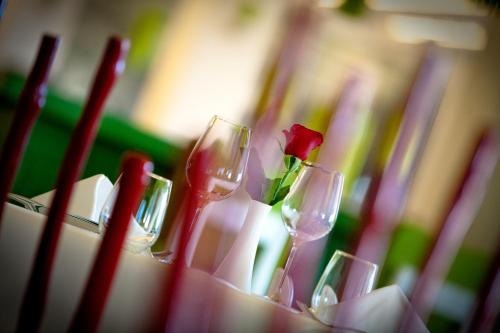 a group of wine glasses with a rose in them at Salvator Villas & Spa Hotel in Parga