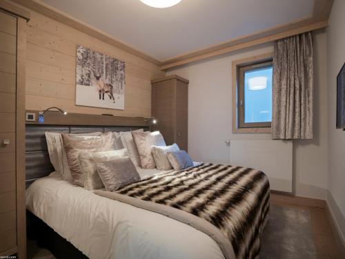 ein Schlafzimmer mit einem großen Bett mit einer Zebradecke in der Unterkunft Appartement de Charme à Courchevel Village - 4 pièces pour 7 personnes avec Garage - FR-1-575-26 in Courchevel