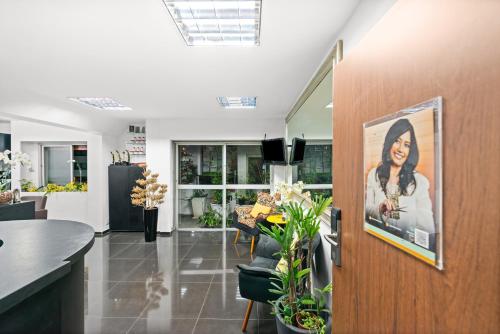 a lobby with a picture of a woman on the wall at Capcana Hotel Jardins in Sao Paulo