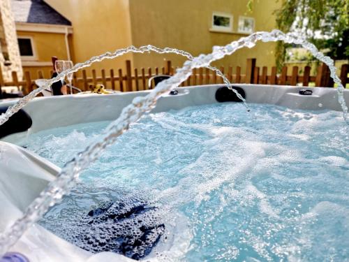 a hot tub with water coming out of it at The Hamilton luxury holiday let's- The Coach House with hot tub in Scorton