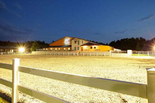 a white fence in front of a white house at Master Horse Club - Svojetice in Svojetice