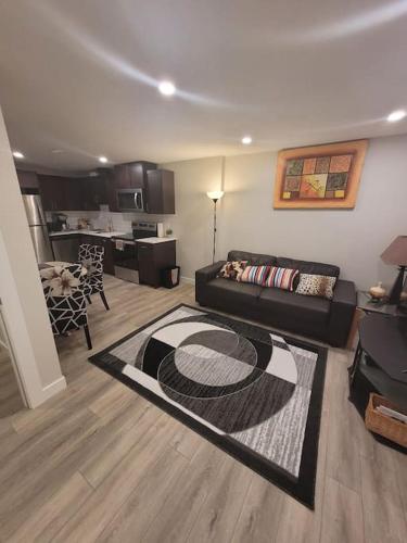 a living room with a couch and a kitchen at Cozy brand new 2 bedroom suite in Calgary in Calgary