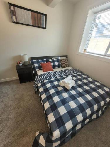 a bedroom with two beds and a window at Cozy brand new 2 bedroom suite in Calgary in Calgary