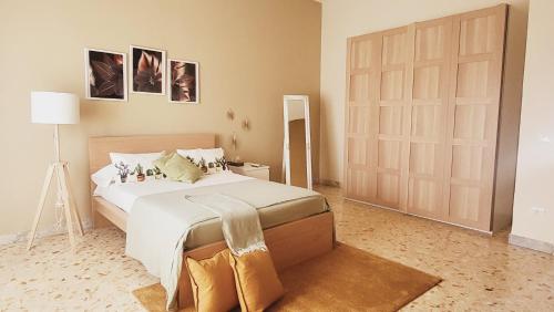 a bedroom with a large bed and a sliding door at Sole raggiante Lia Darzillo in Afragola