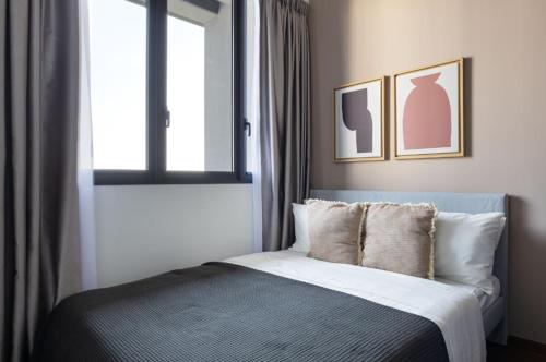 een slaapkamer met een bed met een raam en een bed sidx sidx sidx bij Sunny 1BR / 1Bath apartment in Singapore! in Singapore