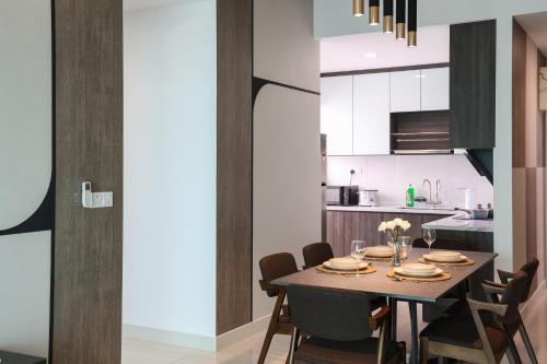 a dining room and kitchen with a table and chairs at Greenfield Residence, Bandar Sunway by The Comfort Zone in Petaling Jaya