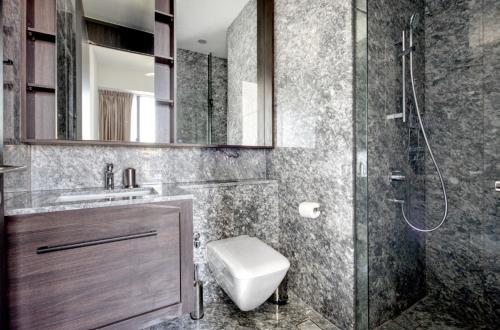 a bathroom with a shower and a toilet and a sink at Sunny 1BR / 1Bath apartment in Singapore! in Singapore