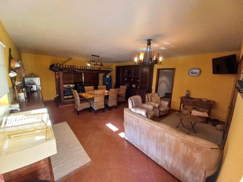 a living room with a couch and a table at Casa do Corgo in Ermida