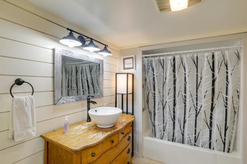 a bathroom with a sink and a mirror at Riverfront New Hampshire Cottage with Boat Dock in Manchester