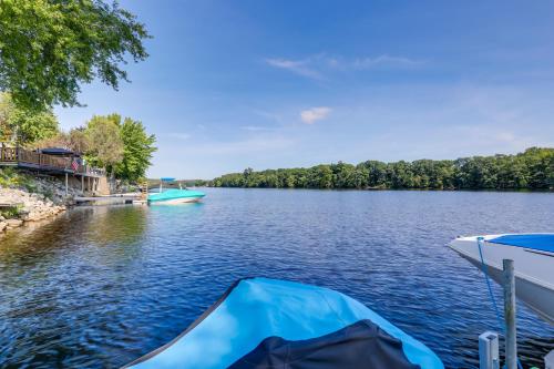 a boat is docked on a lake at Riverfront New Hampshire Cottage with Boat Dock in Manchester