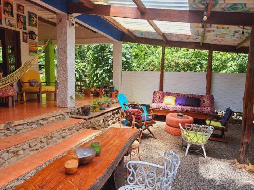 a screened in porch with chairs and a table at Macondo Hostel in Isla Grande
