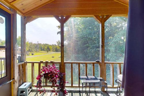 a screened in porch with a vase of flowers at Seneca Lake Serenity & Sunny Serenity in Hector