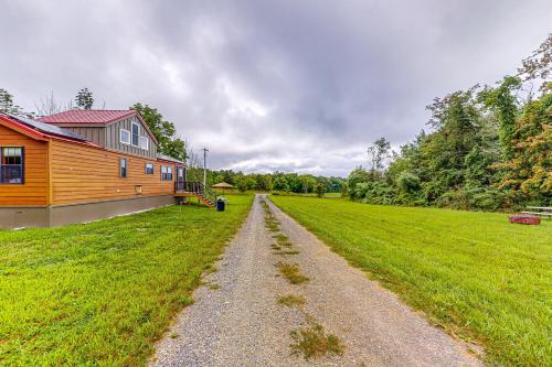 a dirt road next to a house and a field at Seneca Lake Serenity & Sunny Serenity in Hector