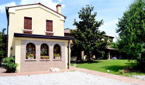 a dog laying in front of a house at B&B Casa Camilla in Padova