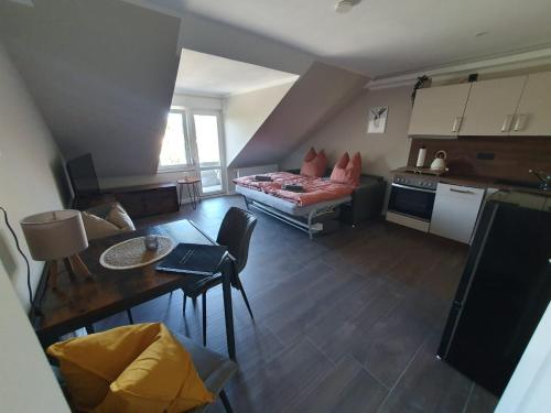a living room with a couch and a table at Neumühler Hof- Ferienwohnung "Benjamin" mit großer Privater Dachterasse und guter Anbindung in die City in Schwerin
