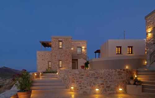 a house with lights on the stairs at night at Themonies Luxury Suites in Chora Folegandros