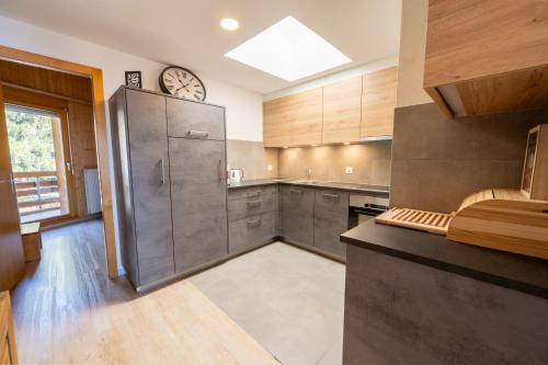 a kitchen with a large stainless steel refrigerator at Eden Resort Anzère in Anzère