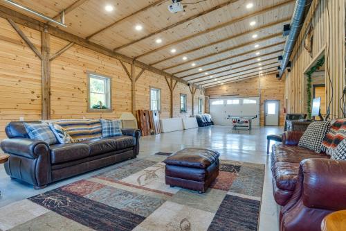 a living room with leather furniture in a log cabin at Eagle Crest Lodge - Large Group Getaway! in Mitchell
