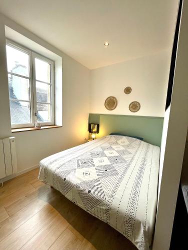 - une chambre avec un lit et 2 fenêtres dans l'établissement Appartement le Regnaudin, à Moulins