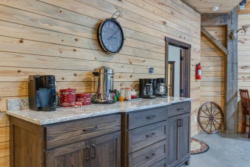 a kitchen with a counter with a clock on the wall at Eagle Crest Lodge - Large Group Getaway! in Mitchell