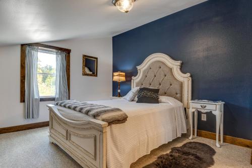 a bedroom with a large bed and a blue wall at Eagle Crest Lodge - Large Group Getaway! in Mitchell