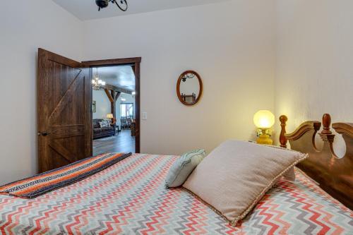 a bedroom with a bed with a pillow and a mirror at Eagle Crest Lodge - Large Group Getaway! in Mitchell