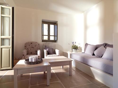 a living room with a couch and a table at Themonies Luxury Suites in Chora Folegandros