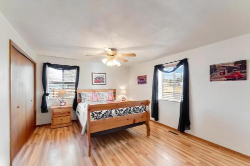 a bedroom with a bed and a ceiling fan at Williams AZ Vacation Home in Williams