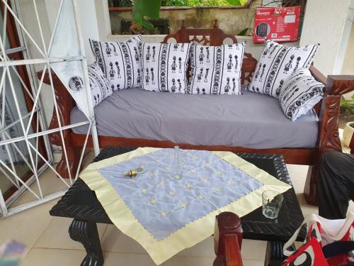 a room with a bed with a table with a table at Diani Hideaway Beach Villa, private pool, air conditioning and WiFi in Galu
