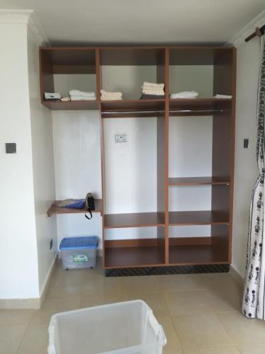 a room with a wooden book shelf in a room at Diani Hideaway Beach Villa, private pool, air conditioning and WiFi in Galu