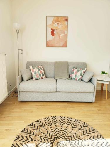 a living room with a couch and a rug at Bright and fully renovated studio in Vanves in Vanves