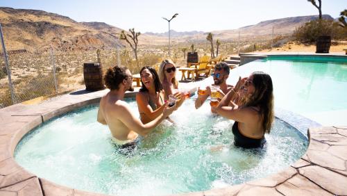 a group of people playing in a swimming pool at Wind Hill in Yucca Valley