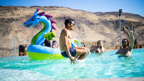 a group of people in the water at a swimming pool at Wind Hill in Yucca Valley