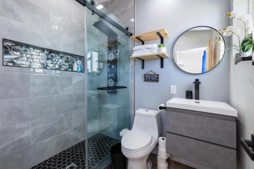 a bathroom with a shower and a toilet and a mirror at Wind Hill in Yucca Valley