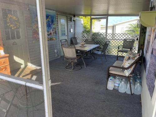 a screened in porch with a table and chairs at Barfoot Bay Beautiful 3/2 in Sebastian