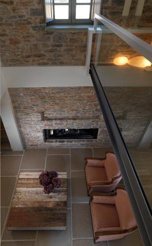 an overhead view of a staircase with chairs and a plant at Themonies Luxury Suites in Chora Folegandros