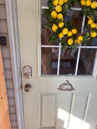 a door with a window with a bunch of oranges on it at Barfoot Bay Beautiful 3/2 in Sebastian