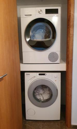 a dryer and a washing machine in a room at Casinha Laranja in Monchique