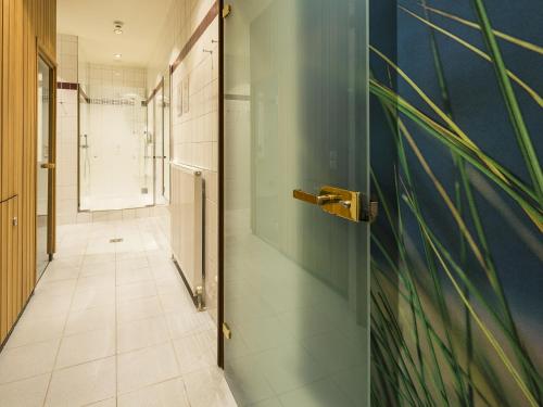 a hallway with a door and a tile floor at Austria Classic Hotel Wien in Vienna