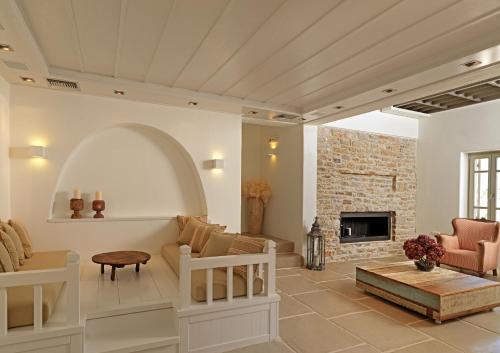 a living room with a couch and a fireplace at Themonies Luxury Suites in Chora Folegandros