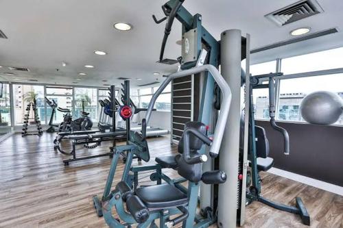 a gym with several tread machines in a building at Suite executiva Park in Radisson Berrini Luxo Queen 17 in Sao Paulo