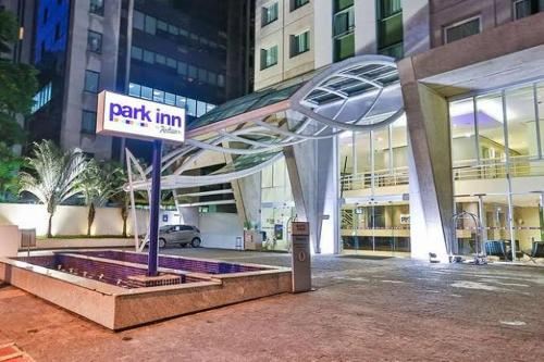 a park inn sign in front of a building at Suite executiva Park in Radisson Berrini Luxo Queen 17 in Sao Paulo