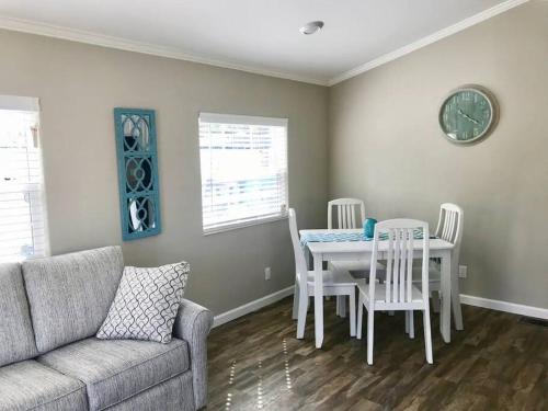a living room with a couch and a table and chairs at Pinecraft Blue Heron Tiny Home in Sarasota