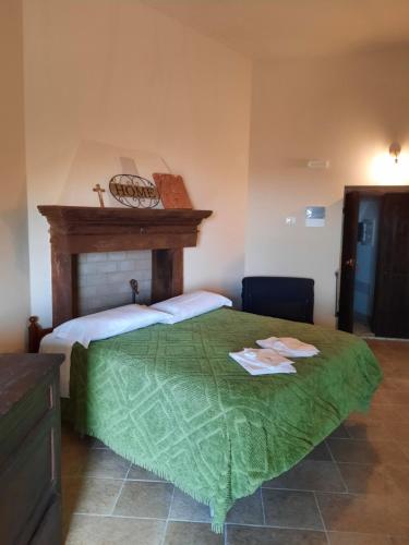 a bedroom with a bed with a cross on top of it at Il sogno in Santo Stefano di Sessanio