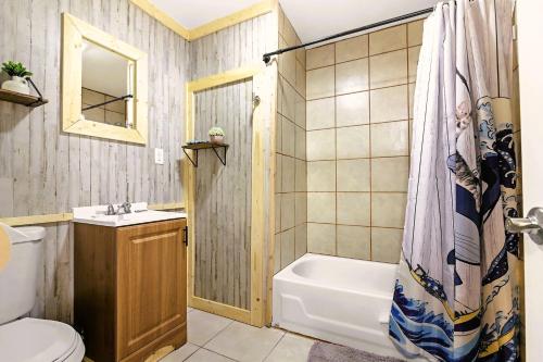 a bathroom with a tub and a toilet and a sink at Leadville Motor Lodge in Leadville